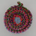 This view is looking down into the fabric rope basket. It shows the variety of all the scraps used to make the rope which made the basket. This view is looking down into the fabric rope basket. It shows the variety of all the scraps used to make the rope which made the basket.